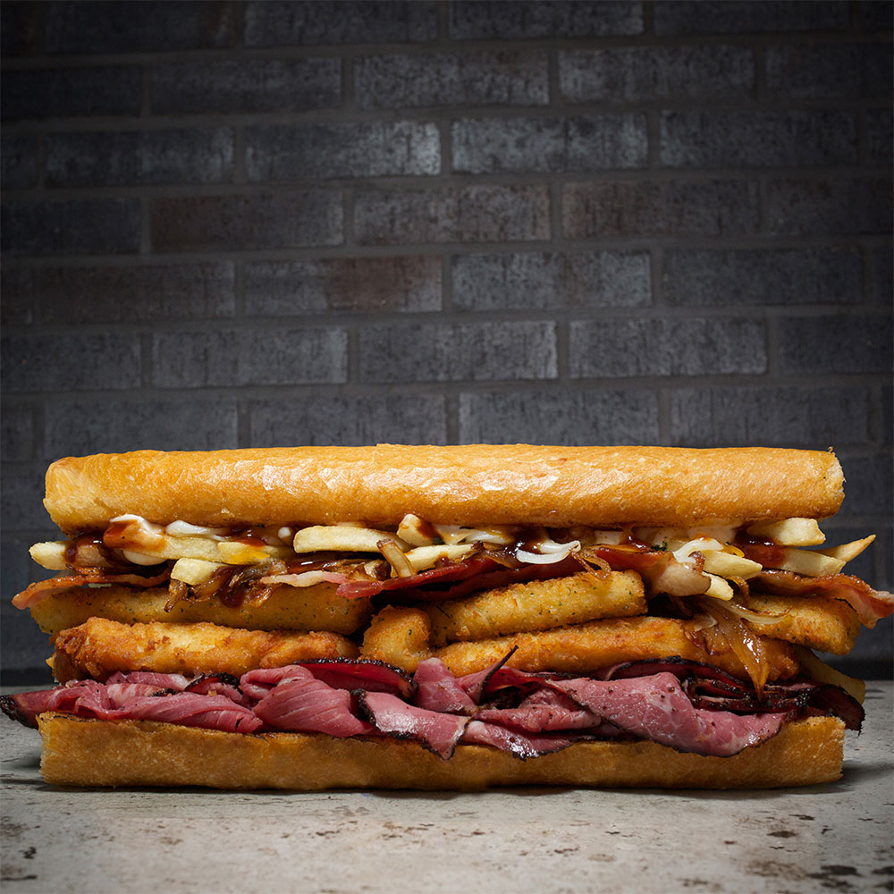 Sandwich with roast beef, mozzarella sticks and french fries